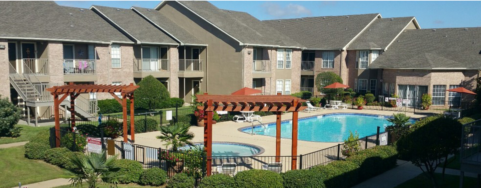 A slight aerial view of the pool at Country Place apartments featuring two gazebos and two pools.